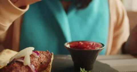 Close-up of a grilled kebab being dipped in tomato sauce. Gourmet grilling and Stock Footage 266110549