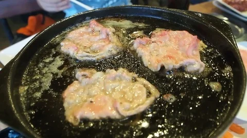 Close up grilled meat on hot pan with butter in Thai Barbecue Buffet restaurant. Stock Footage 83920001