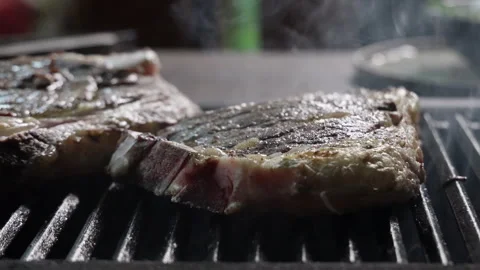 Close-up of the grilled meat steak cooking process 스톡 동영상 280404634