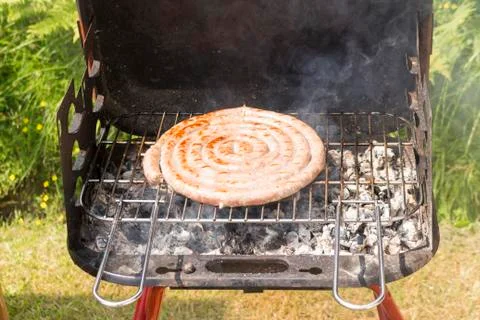 Close up of grilled meat while cooking Stock Photos