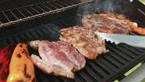 Close-up of grilled steak. The chef flips tasty grilled meat steak. Grilled Stock Footage 202137808