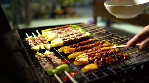 Close up grilling assorted BBQ pork and vegetable on skewers with sauce. Stock Footage 166538241