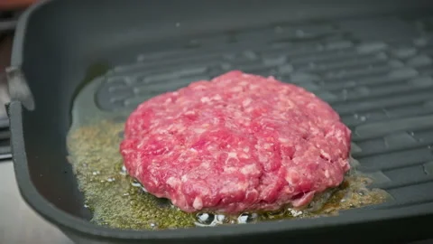 Close-up Grilling beef steak made from mince into a grilling frying pan in 4K. Video stock 153729908