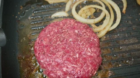 Close-up Grilling beef steak made from mince into a grilling frying pan in 4K. Stock Footage 153755027