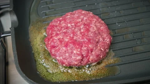 Close-up Grilling beef steak made from mince into a grilling frying pan in 4K. Stock Footage 153820725