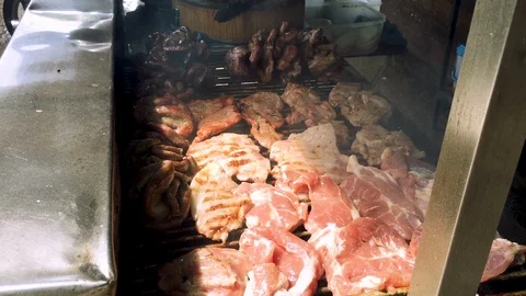 Close up of grilling fresh pork on grill Stock Footage 102729948