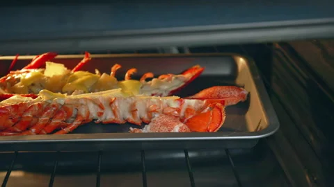 Close-up of grilling marinated with butter red lobster in the oven in 4K. Video stock 146344004