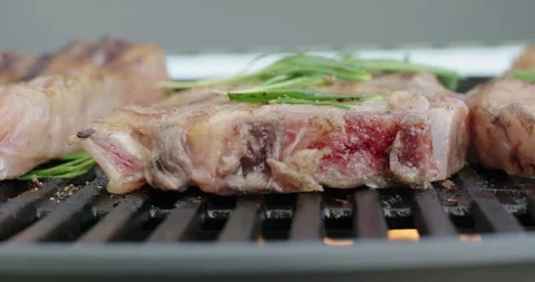 Close-up grilling meat steak on barbecue grid. BBQ grill party. Steak roasting Stock Footage 276129998