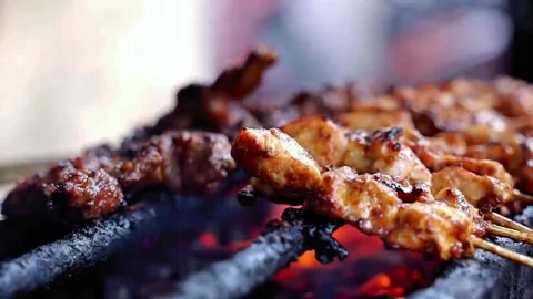 Close up grilling together beef satay and chicken satay together side view Stock Footage 273040616