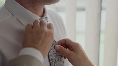 Close-up of groom adjusting his floral t... | Stock Video | Pond5