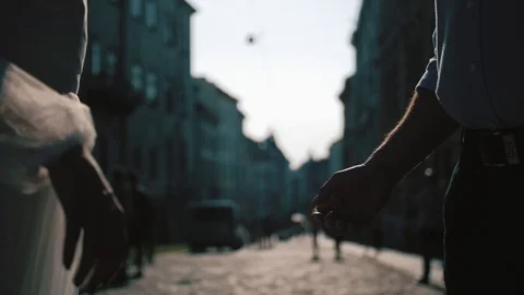 Close up groom and bride hands. Wedding couple holding hands. Beautiful old city Stock Footage 103856981