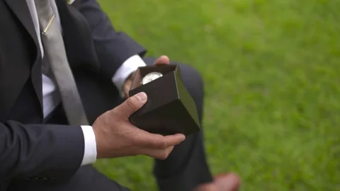 Close up: Groom pulls watch out of black box. Stock Footage 136266608