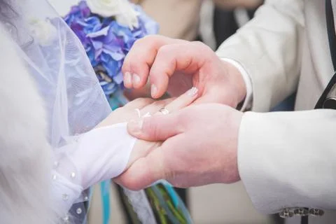 Close up Groom Put the Wedding Ring on bride Stock Photos