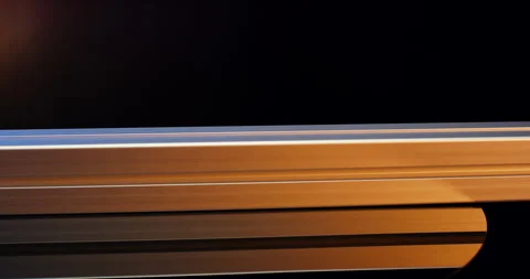 Close up of grooved aluminum profiles in changing orange and blue light Stock Footage 331451608