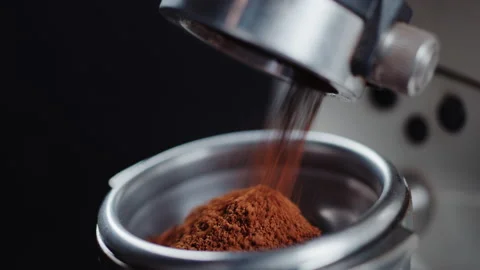 Close-up of ground coffee poured from the grinder machine. Process of making Stock-Footage 153057462