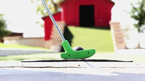 Close up Ground Level View of Ball and Putt during Miniature Golf Game Stock Footage 346243901