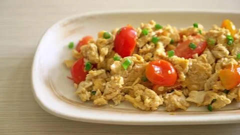 Close-up of ground meat with tomatoes and herbs on a white plate Stock Photos