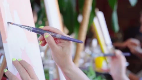 A close-up group of artists on a drawing course hardly paint their paintings Stock Footage 202575170