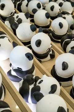 Close-up of a group of ceramic graffiti panda dolls Foto stock