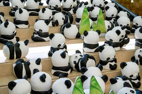 Close-up of a group of ceramic graffiti panda dolls Foto stock
