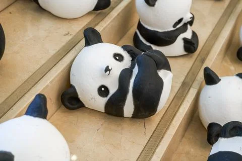 Close-up of a group of ceramic graffiti panda dolls Foto stock