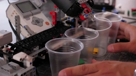 Close-up of group of children playing with robots assembled in a robotics school Stock Footage 142011593