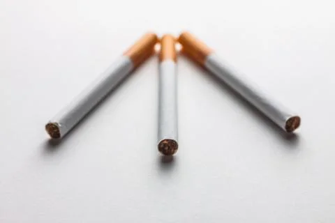 Close-up of a group of cigarettes on a blank surface Stock Photos