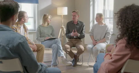 Close Up Group of Diverse People Talking and Sitting in a Circle During Group Stock Footage 156264116