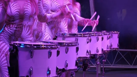 A close-up of a group of female drummers performing in the circus arena. Stock Footage 309084897