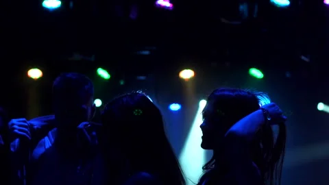 Close-up of a group of friends dancing in the dark Stock Footage 86163929