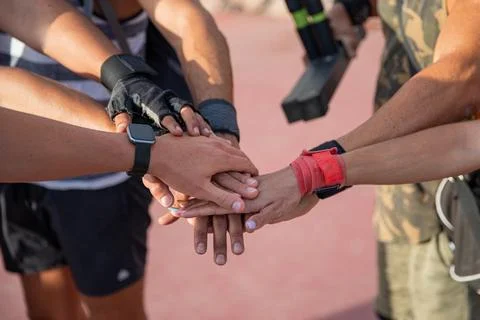 Close up on a group of hands, one on top of the other, a group of sportspeopl Foto stock