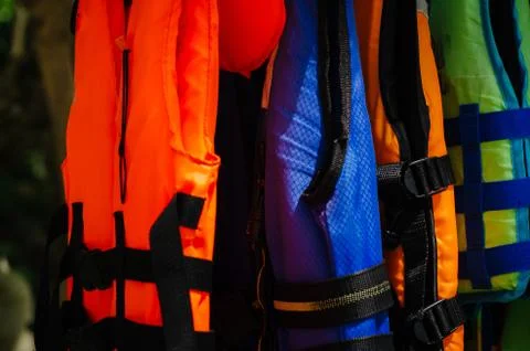 Close-up group of Life jacket or life vest hanging under the shelter at Pangk Stock Photos