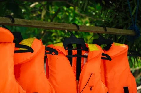 Close-up group of Life jacket or life vest hanging under the shelter at Pangk Stock Photos