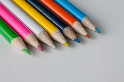 Close-up of a group of multicolored pencils on a white surface Stock Photos