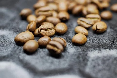 Close-up of a group of roasted coffee beans on a black baking tray background Stock Photos
