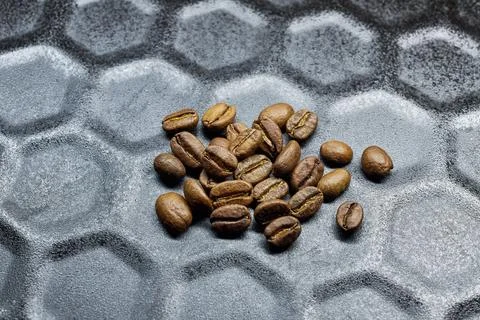 Close-up of a group of roasted coffee beans on a black baking tray background Stock Photos