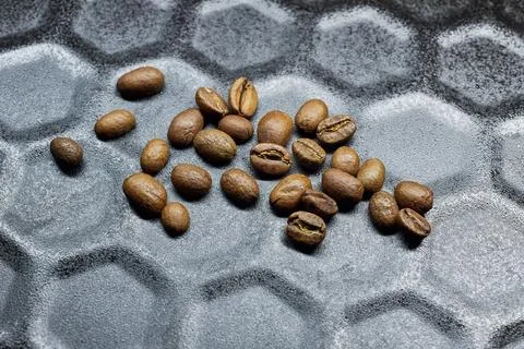 Close-up of a group of roasted coffee beans on a black baking tray background Stock Photos