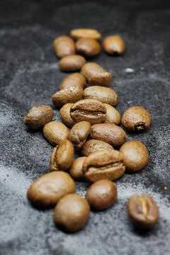 Close-up of a group of roasted coffee beans on a black baking tray background Stock Photos