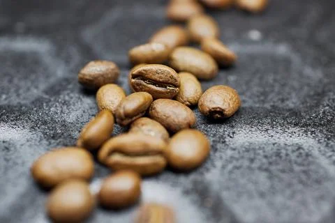 Close-up of a group of roasted coffee beans on a black baking tray background Stock Photos