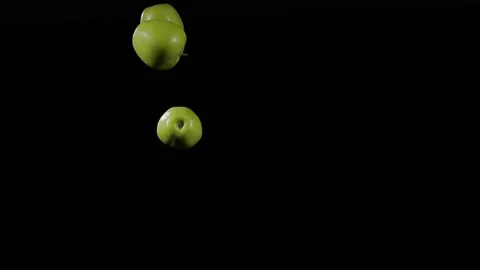 Close up at the group of three green apples fly up and spinning Stock Footage 152789647