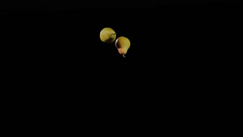 Close up at the group of two fresh pears fly up and spinning in slow motion Stock Footage 152789323