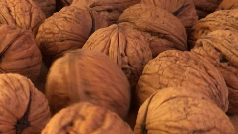Close-up. A group of walnuts lie on the table Video stock 234998573