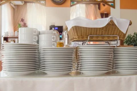 Close-up of a group of white ceramic tea cups and plates standing on a table  Stock Photos