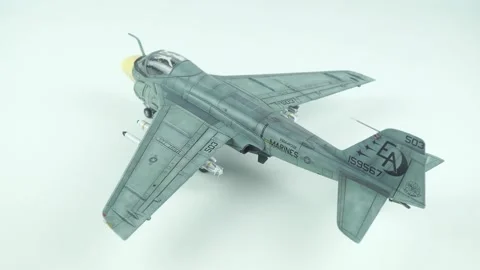 Close up of Grumman A-6 Intruder scale model airplane on clean white studio Stock Footage 341486422
