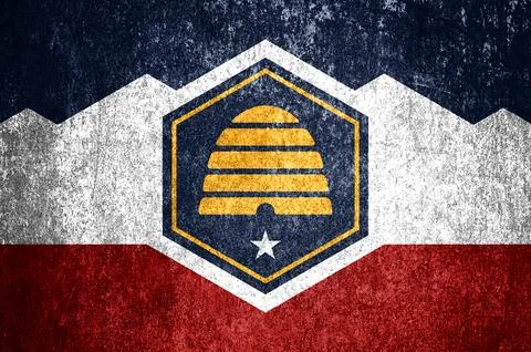 Close-up of the grunge Utah state flag. Dirty Utah state flag on a metal su.. Stock Illustration