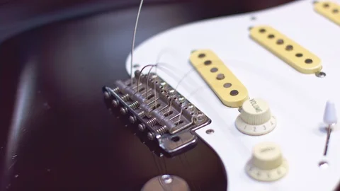 Close up of guitar bridge with strings Stockbeeldmateriaal 118017509