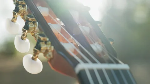 Close-up of the guitar head of a classical guitar with gold pegs. Part of a.. Stock Footage 302865979