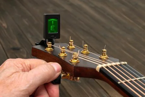 Close-up of a guitar neck while tuning. Stock Photos