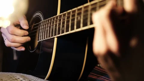 Close-up Guitar Play under Glowing Bulb Stock Footage 301542277