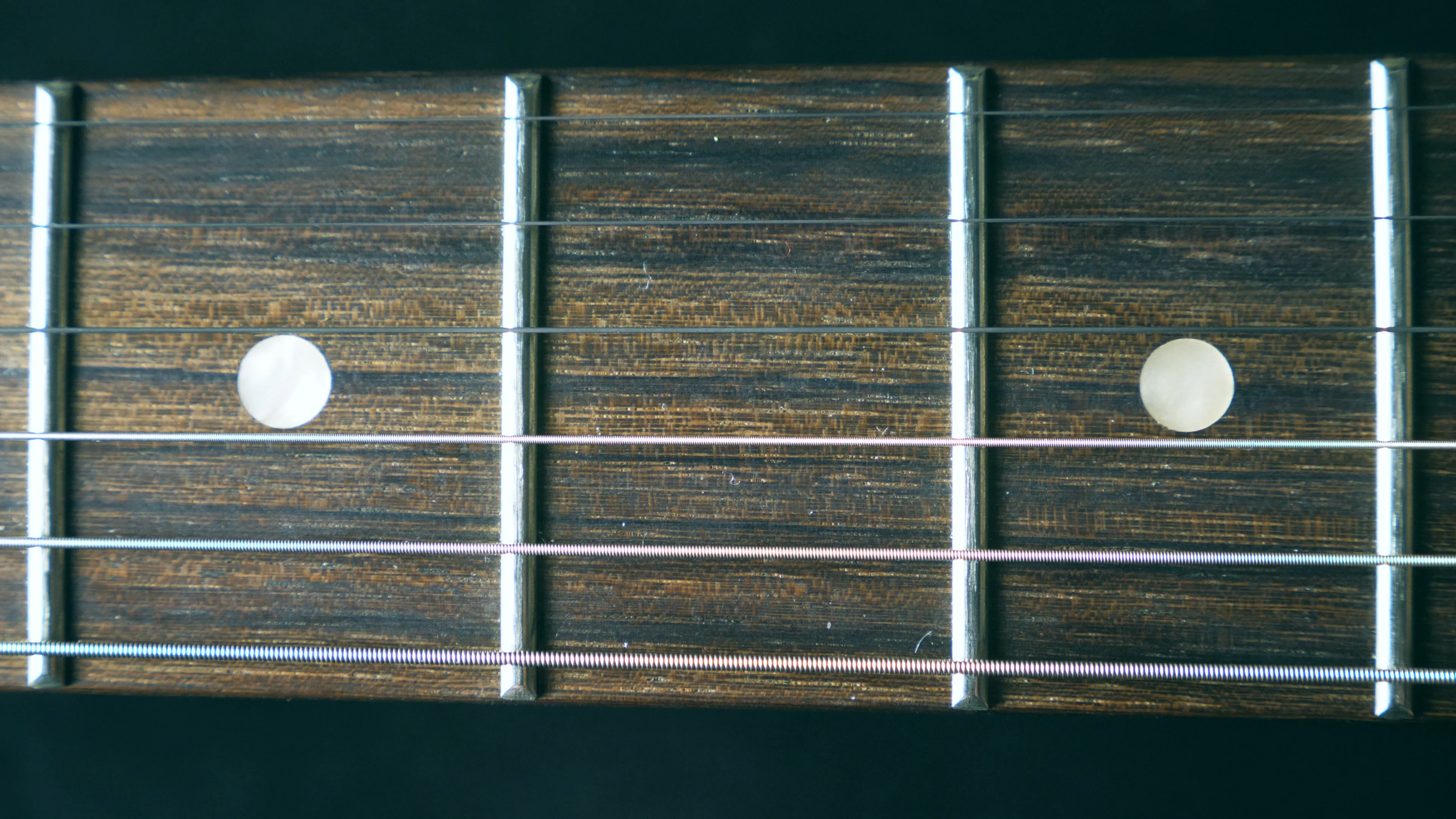 Close up of guitar string vibrating during playing. Cord being strummed